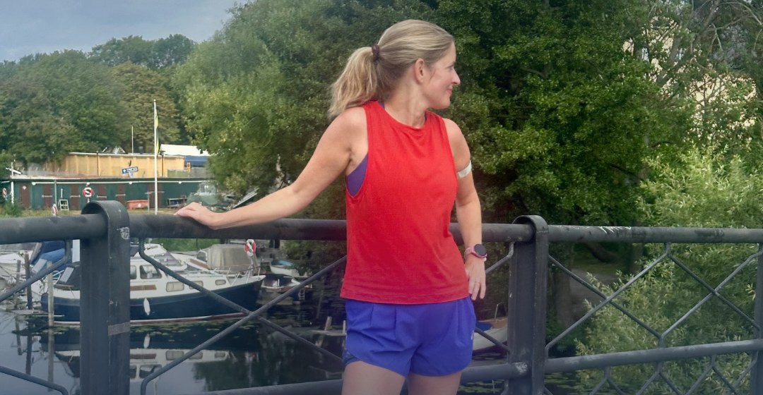 Amanda Hultin lutar sig mot ett räcke på en bro vid en småbåtshamn